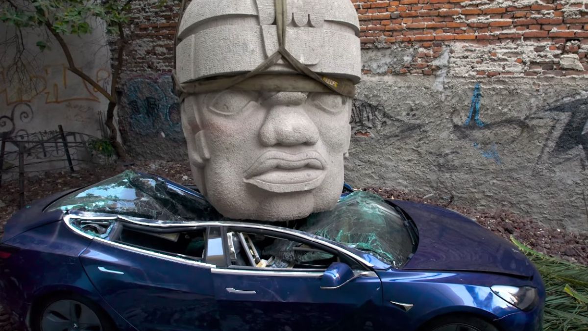 Giant olmec Stone Head Crashes from Sky! Watch a Tesla Get Destroyed [VIDEO]